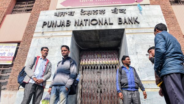 People look on as they stand in front of a closed outlet of Punjab National Bank during a nationwide bank strike in Amritsar on January 31, 2020 - Sputnik International