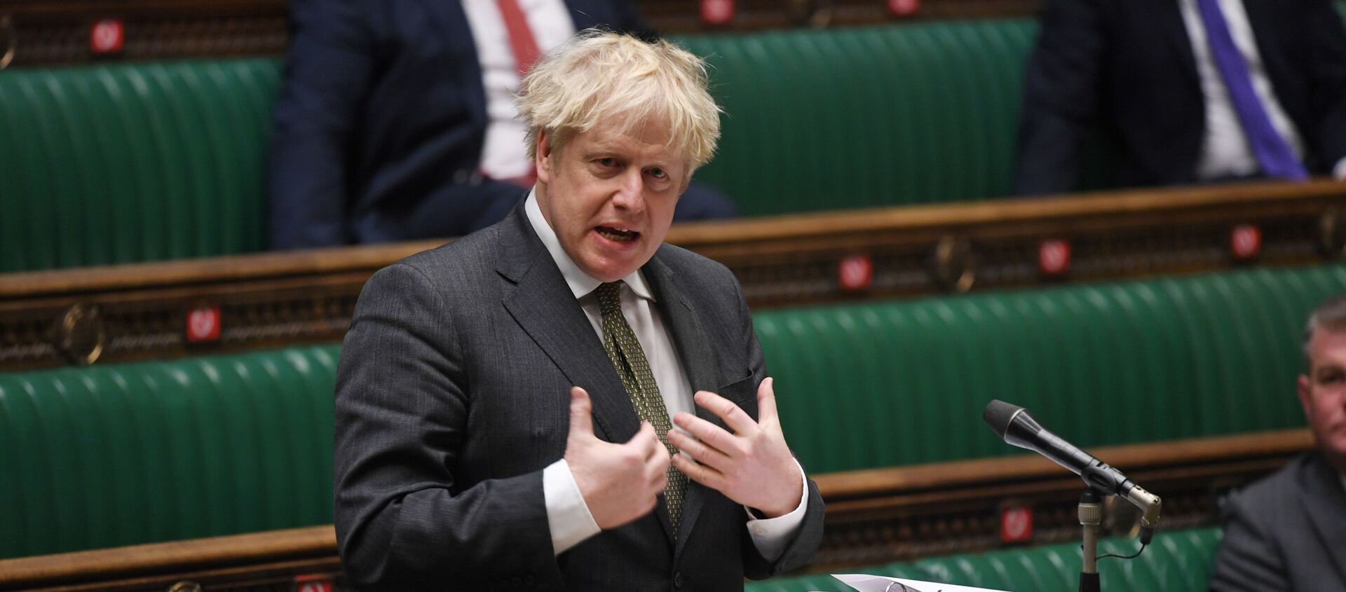 A handout photograph released by the UK Parliament shows Britain's Prime Minister Boris Johnson speaking during Prime Minister's Questions (PMQs) in the House of Commons, in central London on December 9, 2020. - Sputnik International, 1920, 27.12.2020
