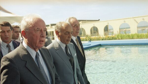 Israeli Prime Minister Yitzhak Rabin, left, walks next to King Hasan II of Morocco and Israeli's Foreign Minister Shimon Peres, right, shortly upon their arrival on Tuesday, Sept. 14, 1993 in Rabat. - Sputnik International