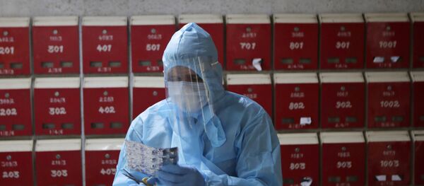 A doctor engages in screening of residents at an apartment complex for COVID-19 symptoms in Mumbai, India, Tuesday, July 28, 2020. A doctor engages in screening of residents at an apartment complex for COVID-19 symptoms in Mumbai, India, Tuesday, July 28, 2020. - Sputnik International