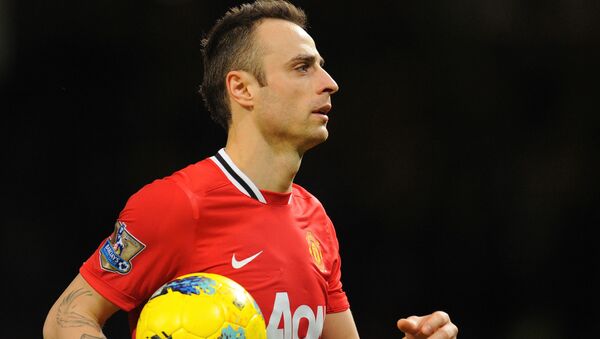 Manchester United's Bulgarian striker Dimitar Berbatov leaves the pitch with the match ball after scoring a hat trick during the English Premier League football match between Manchester United and Wigan Athletic at Old Trafford in Manchester, north-west England on December 26, 2011 - Sputnik International