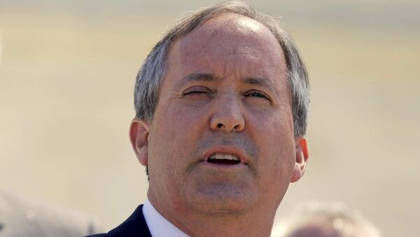 Texas Attorney General Ken Paxton speaks outside the U.S. Supreme Court after justices heard arguments in a challenge by 26 states over the constitutionality of President Barack Obama's executive action to defer deportation of certain immigrant children and parents who are in the country illegally in Washington, D.C., U.S. April 18, 2016. REUTERS/Joshua Roberts/File Photo - Sputnik International