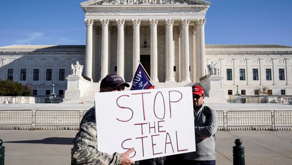 Supporters of U.S. President Donald Trump stand in front of the Supreme Court as the court reviews a lawsuit filed by Texas seeking to undo President-elect Joe Biden's election victory in Washington, U.S., December 11, 2020. - Sputnik International