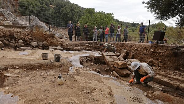 Employees with Israel Nature and Parks Authority are pictured during preservation work of a Hellenistic, Roman and the Byzantine periods site, at the Banias Nature Reserve in the Israeli-annexed Golan Heights on November 11, 2020. - A church from the Byzantine period built on the basis of a temple to the Greek god Pan was discovered in the Banias Springs Reserve. The church that was discovered dates back to the fourth-fifth centuries AD, when the ancient city of Nias was an important Christian centre with a bishop, after having previously been a significant ritual centre for El Pan in the Hellenistic and Roman periods. (Photo by MENAHEM KAHANA / AFP) - Sputnik International