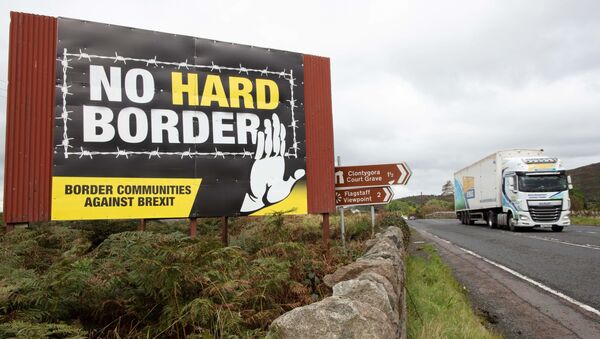  In this file photo taken on 1 October 2019, a freight lorry passes an anti-Brexit pro-Irish unity billboard, pictured from the Dublin road in Newry, on the border between Newry in Northern Ireland and Dundalk in the Irish Republic. - Sputnik International