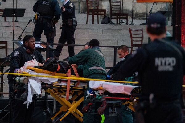 A suspect is taken to an ambulance at the scene where he opened fire outside the Cathedral Church of St. John the Divine in the Manhattan borough of New York City, New York, U.S., December 13, 2020. - Sputnik International