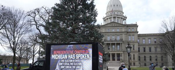 Motorist's participate during a drive-by rally to certify the presidential election results near the Capitol building in Lansing, Mich., Saturday, Nov. 14, 2020 Motorist's participate during a drive-by rally to certify the presidential election results near the Capitol building in Lansing, Mich., Saturday, Nov. 14, 2020 - Sputnik International