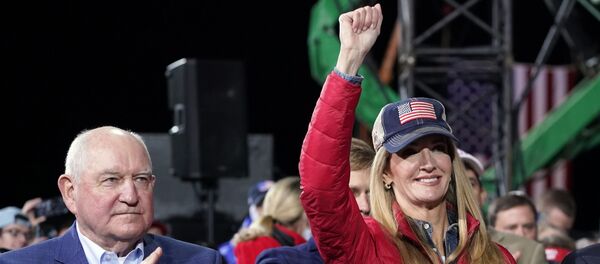 Sen. Kelly Loeffler, R-Ga., listens as President Donald Trump speaks during a campaign rally for Senate Republican candidates, at Valdosta Regional Airport, Saturday, Dec. 5, 2020, in Valdosta, Ga. At left is Agriculture Secretary Sonny Perdue - Sputnik International