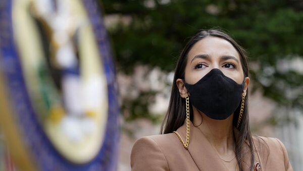 Rep. Alexandria Ocasio-Cortez, D-NY, wears a protective mask as she waits to speak during a news conference outside the USPS Jamaica station, Tuesday, Aug. 18, 2020, in the Queens borough of New York. The Postal Service said it has stopped removing mailboxes and mail-sorting machines amid an outcry from lawmakers, as President Donald Trump denied he was slowing service. Democrats and some Republicans say actions by a Trump ally and a major Republican donor, new Postmaster General Louis DeJoy, have endangered millions of Americans who rely on the Postal Service for prescription drugs and other needs.  - Sputnik International