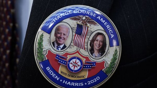 Electoral College elector Mark Miller wears a Joe Biden and Kamala Harris button after electors cast their votes for President of the United States at the state Capitol, Monday, Dec. 14, 2020 in Lansing, Mich. - Sputnik International