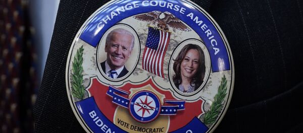 Electoral College elector Mark Miller wears a Joe Biden and Kamala Harris button after electors cast their votes for President of the United States at the state Capitol, Monday, Dec. 14, 2020 in Lansing, Mich. Electoral College elector Mark Miller wears a Joe Biden and Kamala Harris button after electors cast their votes for President of the United States at the state Capitol, Monday, Dec. 14, 2020 in Lansing, Mich. - Sputnik International