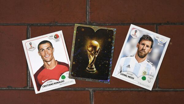 This photo taken on April 20, 2018 shows collectible cards featuring (L-R) Portugal's forward Cristiano Ronaldo, the Fifa World Cup Trophy and Argentina's forward Lionel Messi as part of a series featuring players for the 2018 Russia football World Cup at the Panini Group factory in Modena, northern Italy. - Sputnik International