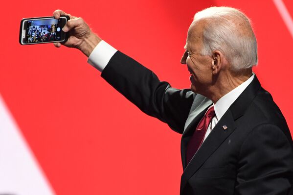 Democratic presidential hopeful former US Vice President Joe Biden takes a selfie with supporters after the fourth Democratic primary debate of the 2020 presidential campaign season, co-hosted by The New York Times and CNN at Otterbein University in Westerville, Ohio on October 15, 2019.  - Sputnik International