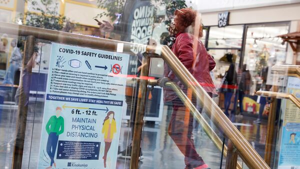 A masked customer ascends a flight of stairs inside Japan Center in Japantown ahead of the new stay-at-home order in attempts to contain the spread of the coronavirus disease (COVID-19) in San Francisco, California, U.S., December 6, 2020 - Sputnik International