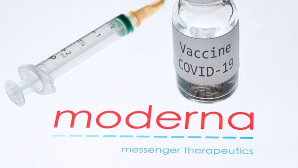 This file photo taken on November 18, 2020 shows a syringe and a bottle reading Vaccine Covid-19 next to the Moderna biotech company logo.  - Sputnik International