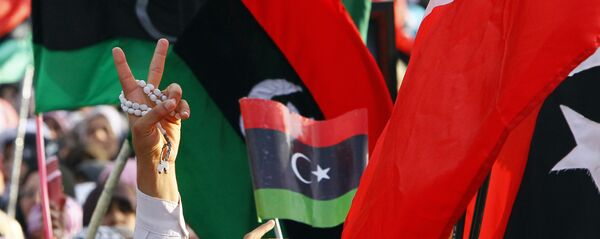 A Libyan flashes the V sign to celebrate at Saha Kish Square in Benghazi, Libya, 23 October 2011 as Libya's transitional government declares the liberation of Libya after months of bloodshed that culminated in the death of longtime leader Moammar Gaddafi. A Libyan flashes the V sign to celebrate at Saha Kish Square in Benghazi, Libya, 23 October 2011 as Libya's transitional government declares the liberation of Libya after months of bloodshed that culminated in the death of longtime leader Moammar Gaddafi. - Sputnik International
