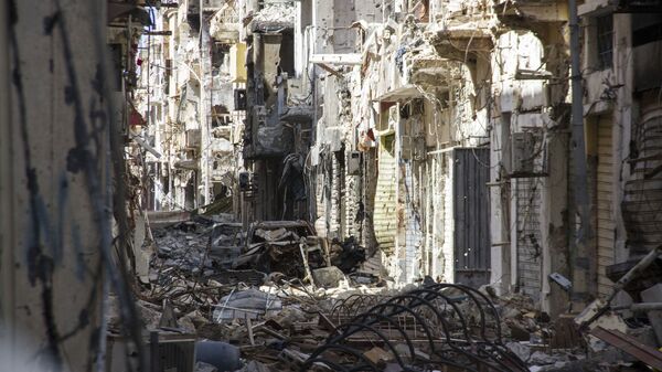 In this photo taken on April 4, 2015, a street is filled with debris and abandoned houses in the city of Benghazi, Libya - Sputnik International