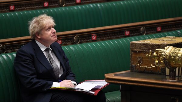 A handout photograph released by the UK Parliament shows Britain's Prime Minister Boris Johnson attending Prime Minister's Questions (PMQs), in a socially distanced and hybrid session of the House of Commons, in central London on December 16, 2020 - Sputnik International