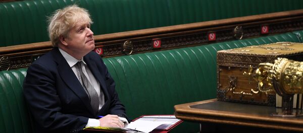 A handout photograph released by the UK Parliament shows Britain's Prime Minister Boris Johnson attending Prime Minister's Questions (PMQs), in a socially distanced and hybrid session of the House of Commons, in central London on December 16, 2020 - Sputnik International