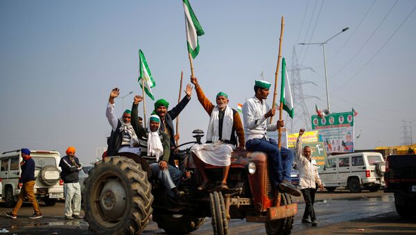 Farmers shout slogans as they sit on a tractor during a protest against farm bills passed by India's parliament, at the Delhi-Uttar Pradesh border in Ghaziabad, India, December 16, 2020 - Sputnik International