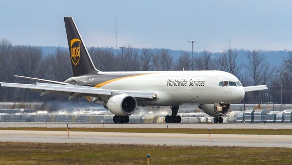 A UPS Boeing 757 carrying two air shipping containers of the Pfizer COVID-19 vaccine lands at Louisville Muhammad Ali International Airport in Louisville, Kentucky, December 13, 2020. - Sputnik International