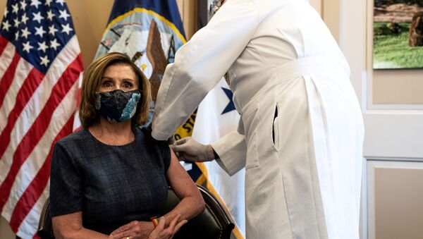 U.S. Speaker of the House Nancy Pelosi (D-CA) receives the Pfizer-BioNTech COVID-19 vaccine by Dr. Brian Monahan, attending physician of the United States Congress, at the Capitol in Washington, U.S., December 18, 2020. Anna Moneymaker/Pool via REUTERS     TPX IMAGES OF THE DAY - Sputnik International