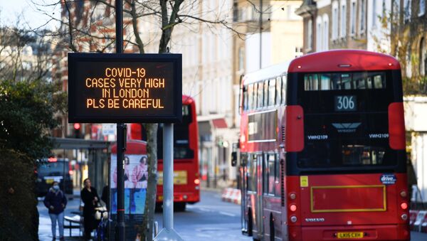 Busses pass a sign with a public health information message, amid the spread of the coronavirus disease (COVID-19), as new restrictions come into force, in London, Britain, December 20, 2020. REUTERS/Toby Melville - Sputnik International