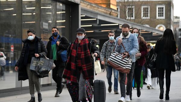 Travellers walk outside of King's Cross station as the British government imposes a stricter tiered set of restrictions amid the coronavirus disease (COVID-19) pandemic, in London, Britain, December 20, 2020 - Sputnik International