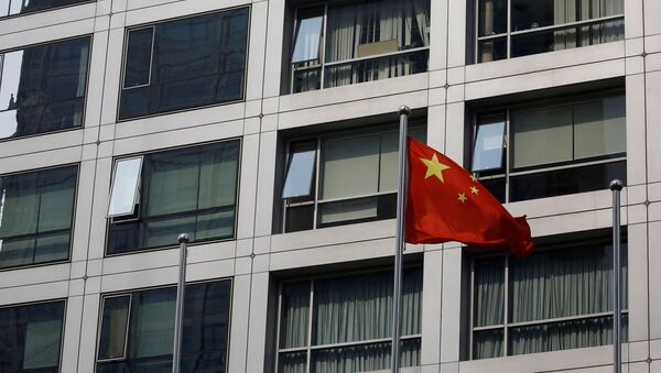 A Chinese national flag flutters near the building of China Securities Regulatory Commission (CSRC) at the Financial Street area in Beijing, China July 16, 2020. - Sputnik International