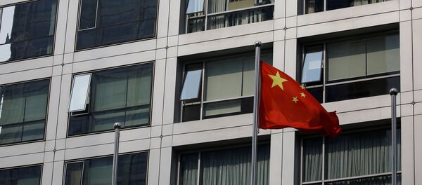 A Chinese national flag flutters near the building of China Securities Regulatory Commission (CSRC) at the Financial Street area in Beijing, China July 16, 2020. - Sputnik International