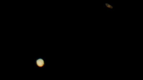 Jupiter (below) and Saturn (above) are pictured on the sky during the closest visible conjunction of them in 400 years, in La Linea de la Concepcion, southern Spain December 21, 2020 - Sputnik International