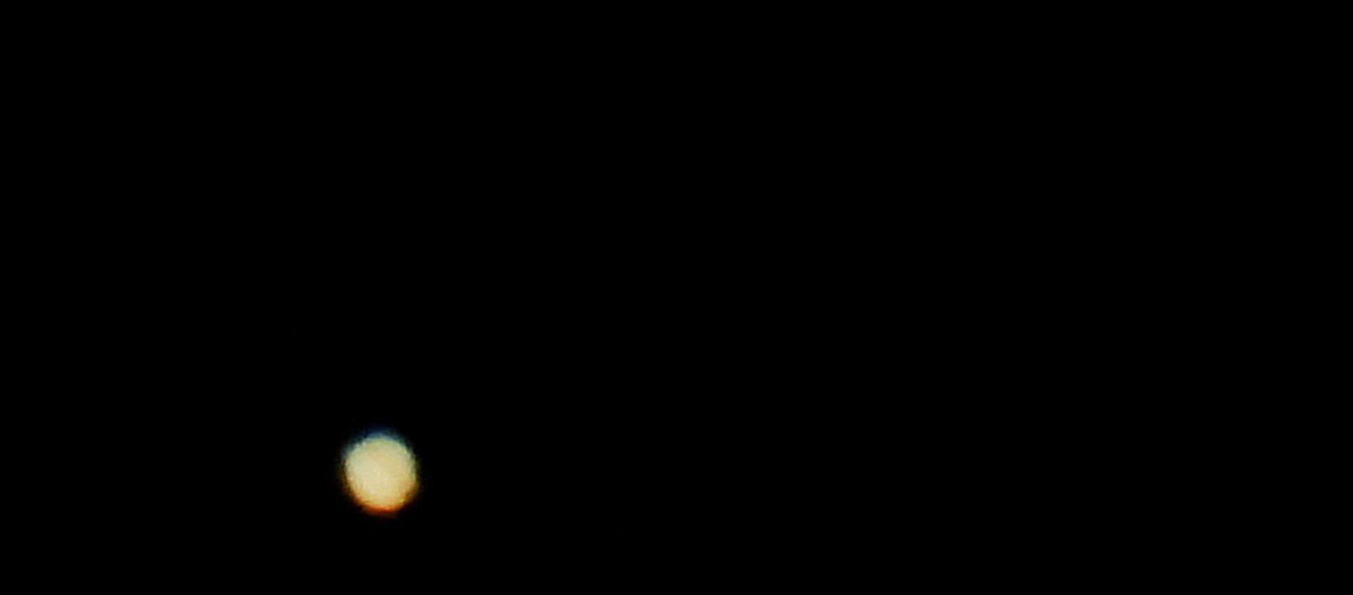 Jupiter (below) and Saturn (above) are pictured on the sky during the closest visible conjunction of them in 400 years, in La Linea de la Concepcion, southern Spain December 21, 2020 - Sputnik International, 1920, 21.12.2020