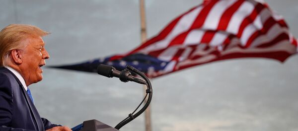 President Donald Trump speaks, with a flag behind him, during a campaign rally at Cecil Airport in Jacksonville, Florida, US, 24 September 2020. - Sputnik International
