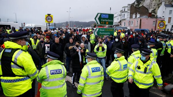 Drivers stand in front of police officers as they block the exit at the Port of Dover, as EU countries impose a travel ban from the UK following the coronavirus disease (COVID-19) outbreak, in Dover, Britain, December 23, 2020 - Sputnik International