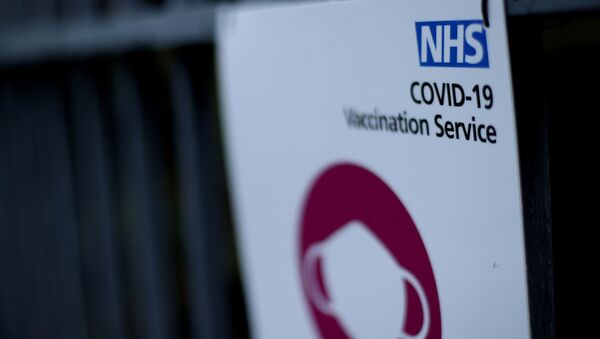 A sign is seen outside a surgery in Wolverhampton, Britain  that is delivering the Pfizer-BioNTech COVID-19 vaccine, 14 December 2020 - Sputnik International
