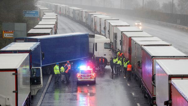 A lorry blocks M20 motorway where trucks queue to port Dover, as EU countries impose a travel ban from the UK following the coronavirus disease (COVID-19) outbreak, near Ashford, Britain, December 23, 2020. - Sputnik International