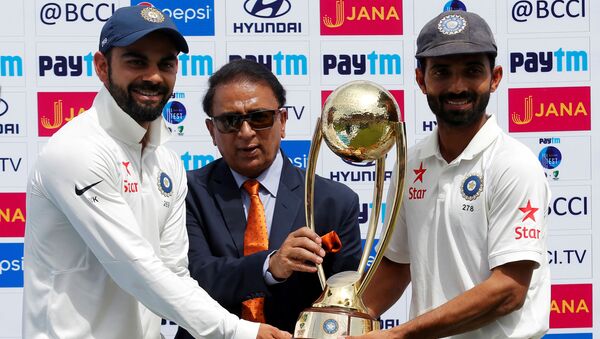 Cricket - India v Australia - Fourth Test cricket match - Himachal Pradesh Cricket Association Stadium, Dharamsala, India - 28/03/17 - India's Virat Kohli (L) and Ajinkya Rahane (R) receive the trophy from the former Indian cricket player Sunil Gavaskar after winning the series - Sputnik International