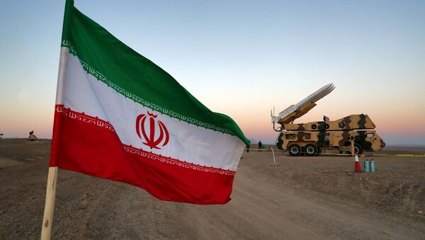 An Iranian flag is pictured near in a missile during a military drill, with the participation of Iran’s Air Defense units, Iran October 19, 2020. - Sputnik International