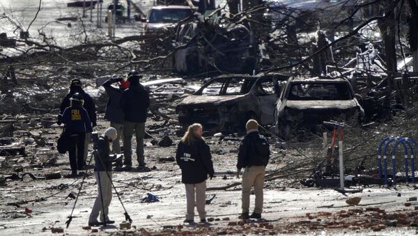 Investigators work near the blast site on 2nd Avenue in Nashville, Tennessee on 26 December after an RV exploded the day before, injuring four - Sputnik International