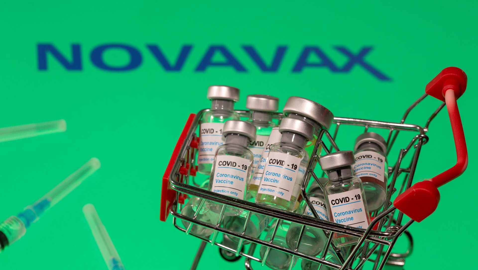FILE PHOTO: A small shopping basket filled with vials labeled COVID-19 - Coronavirus Vaccine and medical sryinges are placed on a Novavax logo in this illustration taken November 29, 2020. Picture taken November 29, 2020. REUTERS/Dado Ruvic/Ilustration/File Photo - Sputnik International, 1920, 29.08.2021