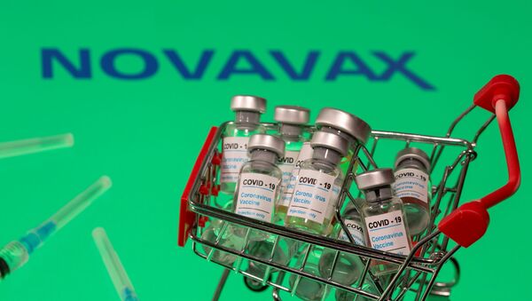 FILE PHOTO: A small shopping basket filled with vials labeled COVID-19 - Coronavirus Vaccine and medical sryinges are placed on a Novavax logo in this illustration taken November 29, 2020. Picture taken November 29, 2020. REUTERS/Dado Ruvic/Ilustration/File Photo - Sputnik International