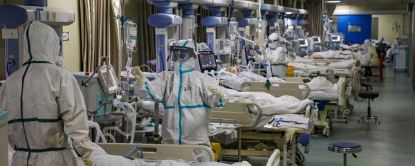 Medical workers in protective suits attend to novel coronavirus patients at the intensive care unit (ICU) of a designated hospital in Wuhan, Hubei Province, China, February 6, 2020.  - Sputnik International