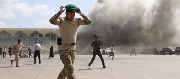 A security personnel member reacts as dust rises after explosions hit Aden airport, upon the arrival of the newly-formed Yemeni government in Aden, Yemen December 30, 2020 A security personnel member reacts as dust rises after explosions hit Aden airport, upon the arrival of the newly-formed Yemeni government in Aden, Yemen December 30, 2020 - Sputnik International