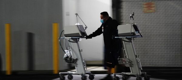 A hospital worker pushes two Computer on Wheels (COW) workstations outside the emergency room at the Community Hospital of Huntington Park during a surge in positive coronavirus cases in Huntington Park, California, U.S. December 29, 2020 A hospital worker pushes two Computer on Wheels (COW) workstations outside the emergency room at the Community Hospital of Huntington Park during a surge in positive coronavirus cases in Huntington Park, California, U.S. December 29, 2020 - Sputnik International