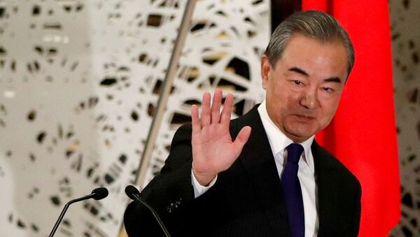 China's State Councillor and Foreign Minister Wang Yi waves as he leaves a news conference in Tokyo, Japan, November 24, 2020. REUTERS/Issei Kato/Pool/File Photo - Sputnik International