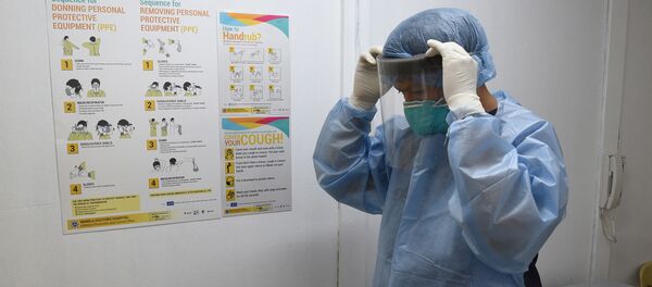 A hospital employee dons protective gear inside the holding area for patients suspected of being infected with a deadly SARS-life virus which originated from the Chinese city of Wuhan, at the Manila Doctors Hospital compound in Manila on January 31, 2020. - The Philippines reported its first case of the virus on January 30, a 38-year-old woman who arrived from Wuhan and is no longer showing symptoms. (Photo by Ted ALJIBE / AFP) - Sputnik International