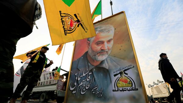 FILE PHOTO: Kataib Hezbollah Iraqi militia hold the picture of the Iranian Major-General Qassem Soleimani, as they gather ahead of the funeral of the Iraqi militia commander Abu Mahdi al-Muhandis, who was killed in an air strike at Baghdad airport, in Baghdad, Iraq, January 4, 2020. - Sputnik International