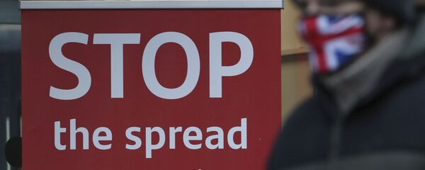 A man wearing a British union flag face mask walks past a coronavirus advice sign outside a bank in Glasgow the morning after stricter lockdown measures came into force for Scotland, Tuesday Jan. 5, 2021. Further measures were put in place Tuesday as part of lockdown restrictions in a bid to halt the spread of the coronavirus. A man wearing a British union flag face mask walks past a coronavirus advice sign outside a bank in Glasgow the morning after stricter lockdown measures came into force for Scotland, Tuesday Jan. 5, 2021. Further measures were put in place Tuesday as part of lockdown restrictions in a bid to halt the spread of the coronavirus. - Sputnik International