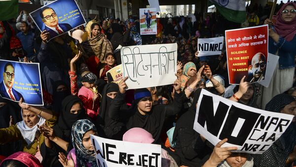 Demonstrators shout slogans and hold placards during a protest against the Indian government's Citizenship Amendment Act (CAA) and the National Register of Citizens (NRC) at Jaffrabad area in New Delhi on February 23, 2020.  - Sputnik International