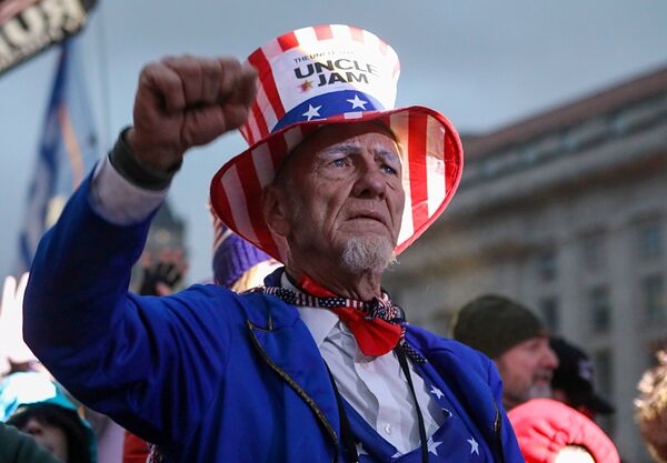 A pro-Trump demonstrator reacts during a rally in Freedom Plaza, ahead of the U.S. Congress certification of the November 2020 election results, 5 January, 2021.  - Sputnik International